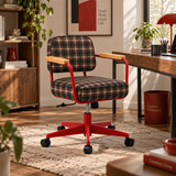 A modern office chair with a red metal frame, black casters, and a brown and beige plaid fabric seat and backrest, shown in a styled home office environment.