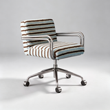 A modern accent chair with a striped textured fabric upholstery in brown, beige, and light blue, featuring a chrome metal frame and a five-star wheeled base, set against a neutral gray studio background.