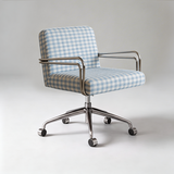 An office chair with a light blue and white gingham patterned fabric upholstery and a polished chrome five-star base with casters, photographed on a neutral light gray studio background.