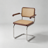 A mid-century modern armchair with a chrome cantilever steel frame, brown leather armrests and seat trim, and a natural woven cane backrest and seat, shown on a light gray studio background.
