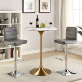 Round bar table with a white marble-look top and gold pedestal base, paired with two grey bar stools.
