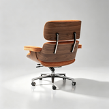 A modern lounge chair with a curved wooden shell, orange-brown upholstered seat and back cushions, and a chrome five-star wheeled base, photographed on a light gray studio background.