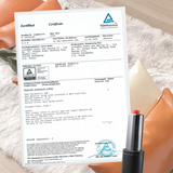 certificate for a packaged product, shown flat on a soft beige fabric background with a black and red pen resting at the bottom right.