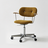 Mustard yellow office chair with textured upholstery, a buttoned backrest, curved arm pads and a silver castor base.