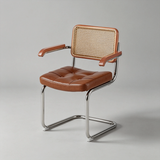 A modern cantilever dining chair with a tufted brown leather seat and backrest, a woven cane back panel, and a chrome steel base, photographed on a light gray studio background.