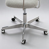 Close-up of the office chair's polished five-star base, height-adjustment column and black castor wheels.