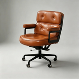 Cognac office chair with two tufted back cushions, padded armrests and a black five-star castor base.