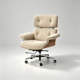 A modern lounge chair with a tufted beige fabric seat and backrest, supported by a curved wooden frame and a chrome five-star swivel base with casters, photographed on a light gray studio background.