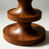 Close-up of the brown stool's stacked pedestal base showing smooth curves, circular tiers and natural wood grain.