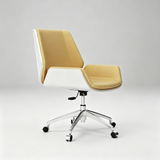 A modern office chair with a mustard yellow upholstered seat and backrest, white side panels, and a chrome five-star base with black casters, shown against a light gray studio background.