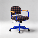 A modern office chair with a blue metal frame, black five-star base with casters, and light wood armrests. The seat and back cushions are upholstered in a dark navy and red plaid fabric, set against a neutral gray studio background.