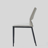 Sleek and Modern: White Leather Dining Chair with Ergonomic Design and Sturdy Black Legs