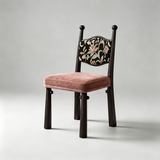 Ebony-frame dining chair with a dusty pink seat cushion and a black floral-patterned padded backrest.