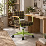 A modern office chair with a green plaid upholstered seat and back, light wood armrests, and a lime green metal base with black casters, shown in a styled home office setting next to a wooden desk.