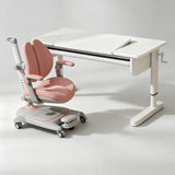 A children's desk and ergonomic chair set in a clean studio setting. The desk is white with a built-in storage drawer and a crank handle on the right side.