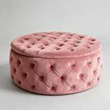 A round, tufted velvet ottoman stool in a dusty rose pink color, shown on a neutral light gray background.