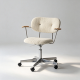 Ivory boucle office chair with a padded seat, buttoned backrest, wooden arm pads and a polished castor base.