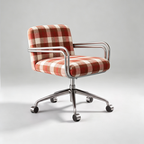 A modern office chair with a red and beige checkered fabric upholstery and a chrome five-star base with casters, photographed on a light gray studio background.