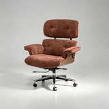A mid-century modern lounge chair with a warm brown velvet upholstered seat and backrest, supported by a curved wood-look frame and a chrome five-star rolling base, photographed on a light gray studio background.