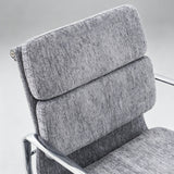 Close-up of a modern office chair with textured gray fabric upholstery and a chrome metal frame, showing the backrest and armrests against a light gray background.
