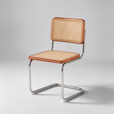 A modern cantilever dining chair with a light tan woven cane backrest and seat, accented by warm brown wood trim and a polished chrome metal base, shown against a neutral light gray background.