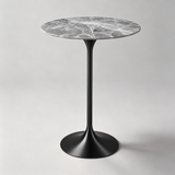 Round bar table with a grey top, branching white veins and a black pedestal base.