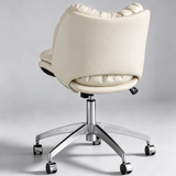 Rear view of a cream upholstered office chair with a curved outer back, height-adjustment lever and chrome five-star base with castors.
