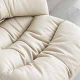 Close-up of the office chair's cream padded seat cushion, showing stitched sections, soft folds and raised cushioned edges.
