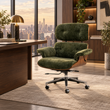 A modern lounge chair with a tufted olive green velvet seat and backrest, mounted on a curved wooden shell and chrome five-star swivel base, set in a luxury office environment with a city skyline view.