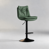 Deep eucalyptus green bar stool with a button-tufted backrest, black pedestal base and oval footrest.