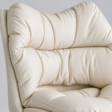 Close-up of the cream office chair's segmented back cushions, showing padded sections, stitched seams and piped edges.
