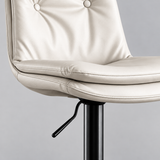Close-up of the ivory layered seat cushion, stitched edges and black height-adjustment lever.

