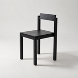 Natural wood dining chair with a rectangular backrest, flat square seat and straight square legs.
