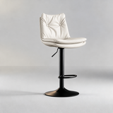 Off-white bar stool with a two-button tufted backrest, layered padded seat, black pedestal base and oval footrest.