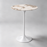 Round bar table with a cream and brown patterned top and white pedestal base.