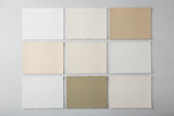 Create a high-resolution, realistic photo taken from a straight-on angle, showcasing a variety of synthetic leather (microfiber leather) samples. Focus on textures such as smooth, pebbled, and matte finishes, primarily in colors like white, off-white, and khaki. The image should highlight the fine details and patterns of the synthetic leather, with good lighting to bring out the richness and texture of the materials. The presentation should be clean, professional, and well-arranged.