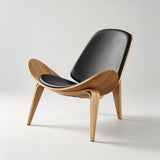 Lounge chair with black padded seat and backrest, a natural wood shell with upswept sides and three splayed legs.
