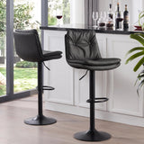 Two black tufted bar stools showing front and rear views beside a white home bar with a dark countertop.