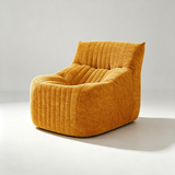 A modern low-profile accent chair upholstered in a textured mustard yellow fabric with vertical channel tufting, shown on a light gray studio background.