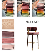 A product collage for a bar stool showing fabric swatches, wood grain, and the assembled stool. The stool has a deep burgundy velvet seat and backrest, dark brown wooden legs, and gold metal accents.