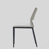 Sleek and Modern: White Leather Dining Chair with Ergonomic Design and Sturdy Black Legs - StoolTopia